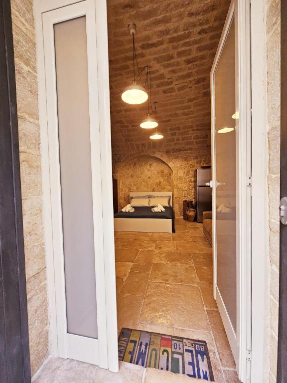 a room with a bed in a brick wall at Nilò holiday house in Molfetta