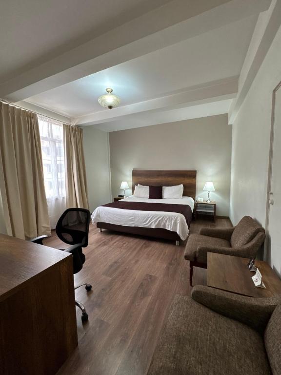 Postel nebo postele na pokoji v ubytování Hotel Nutibara