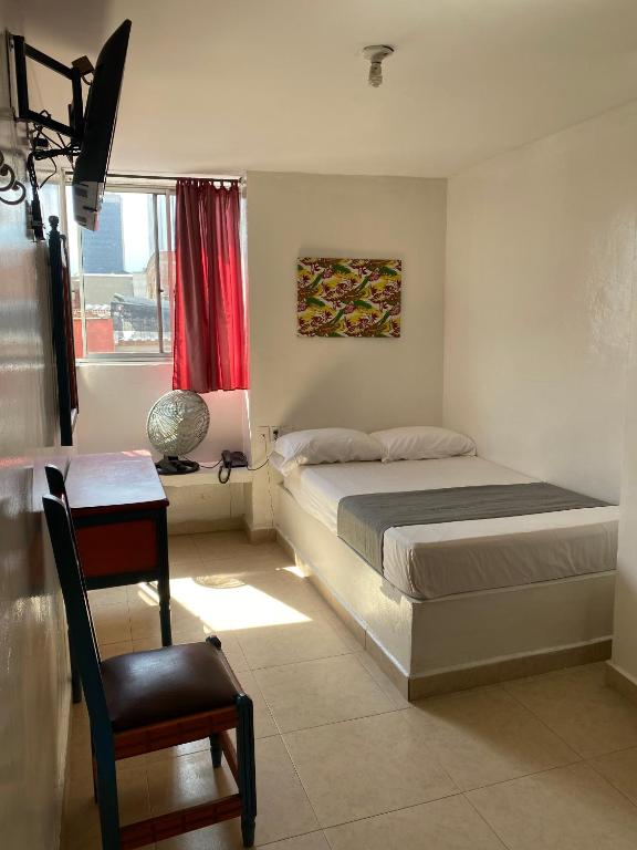 Postel nebo postele na pokoji v ubytování Hotel Conquistadores