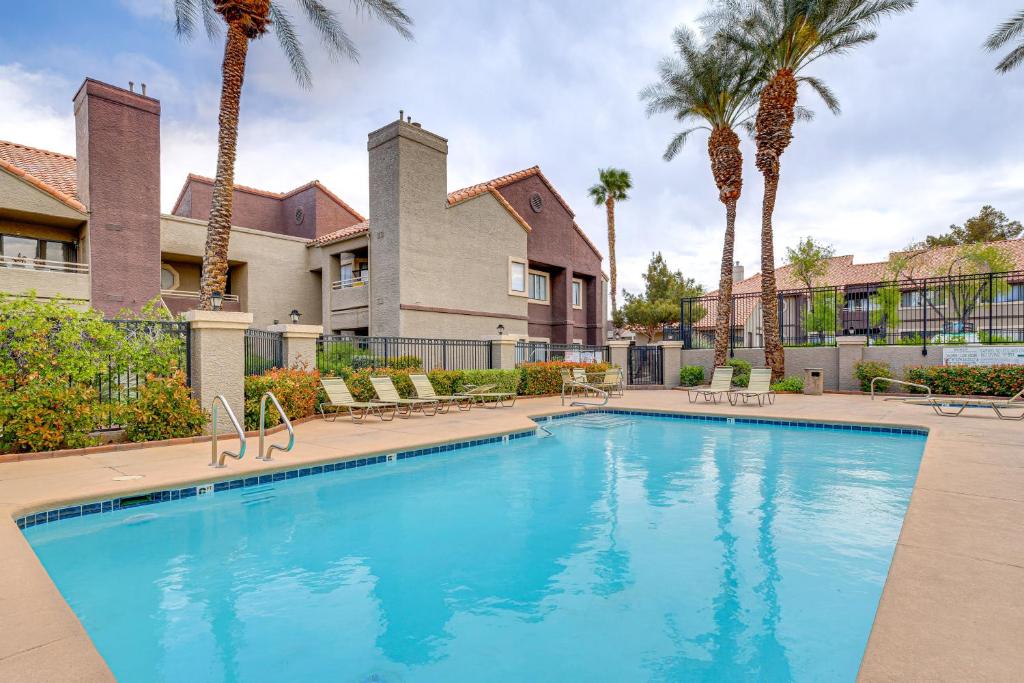 a swimming pool in front of a house with palm trees at 5 Mi to Las Vegas Strip Condo with Community Perks! in Las Vegas