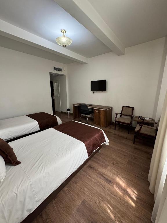Postel nebo postele na pokoji v ubytování Hotel Nutibara