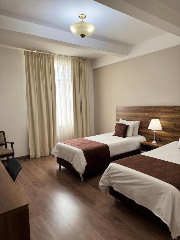Postel nebo postele na pokoji v ubytování Hotel Nutibara