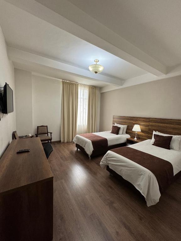 Postel nebo postele na pokoji v ubytování Hotel Nutibara