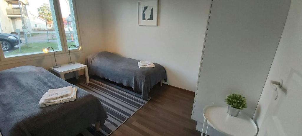 a small room with two beds and a window at Spacious Apartment for 8 with Sauna in Kerava