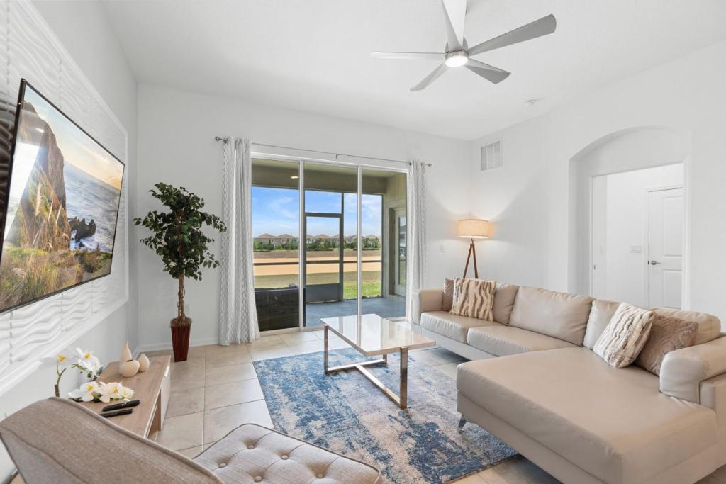 a living room with a couch and a table at Paradise Home 20 Mins to Disney with Pool and Waterpark on Property in Abbeyville