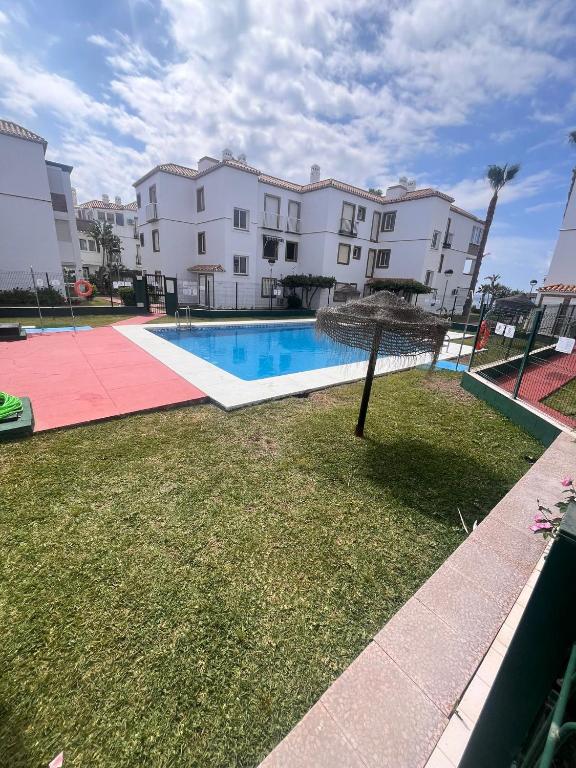 a swimming pool in front of a building at LAGUNA BEACH PISCINA- HOME RENt MALAGA in Torrox Costa