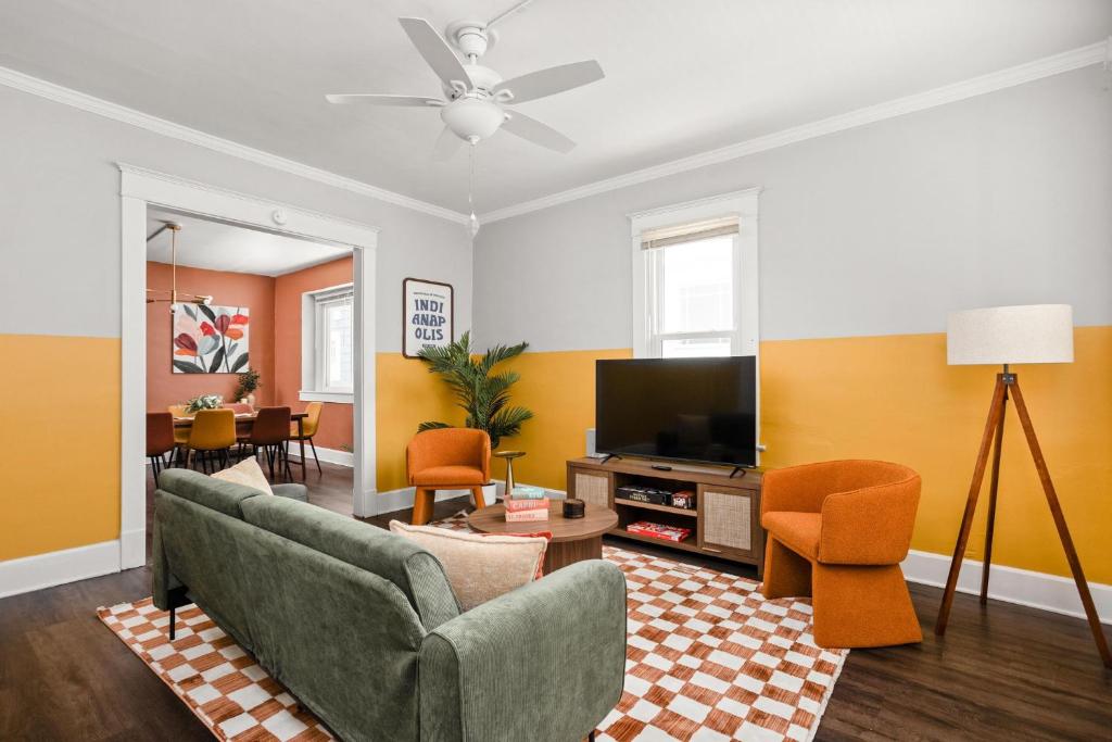 a living room with a couch and a tv at 4BD near Indy 500 Speedway - BBQ & Backyard in Indianapolis