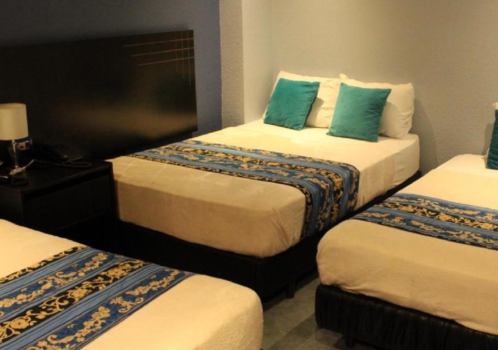 Postel nebo postele na pokoji v ubytování Hotel Del Centro