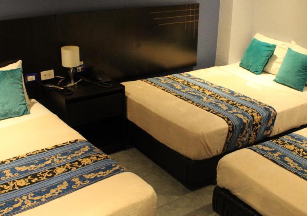 Postel nebo postele na pokoji v ubytování Hotel Del Centro