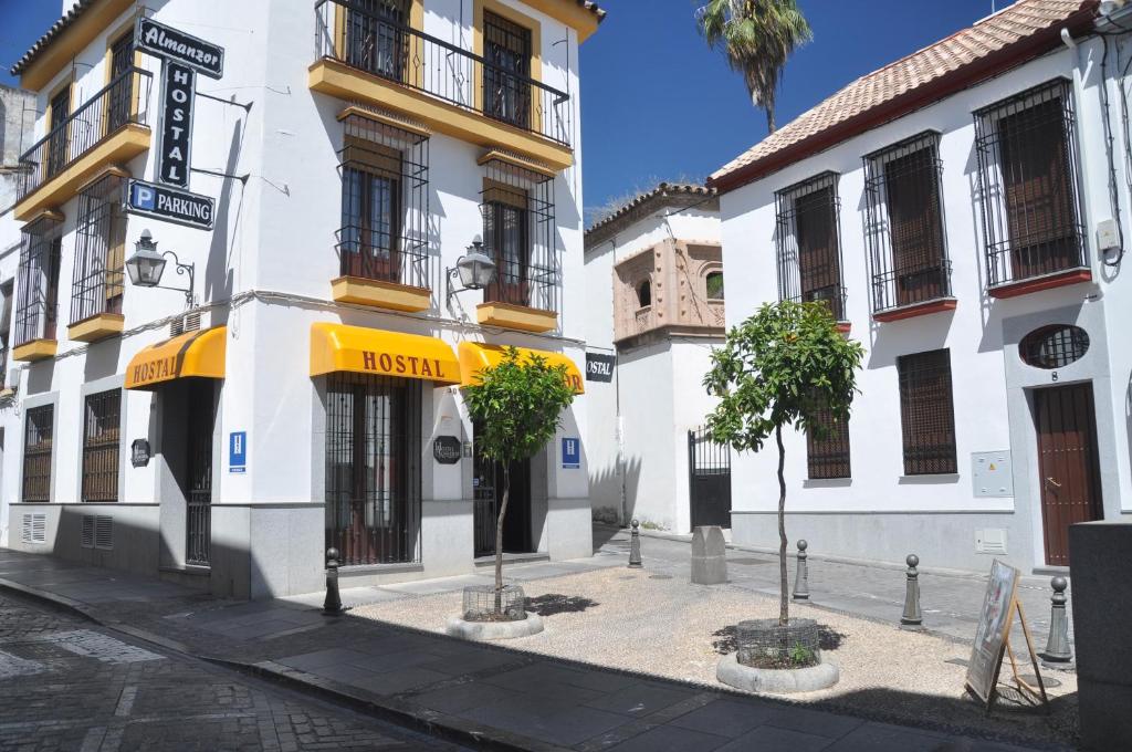 a building with a yellow awning on a street at Hostal Almanzor in Córdoba