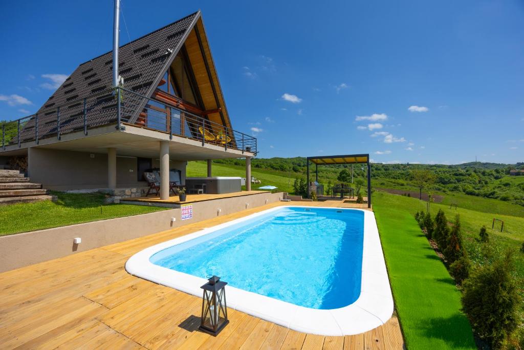 a house with a swimming pool and a building at Kuća za odmor Sokolac in Brinje
