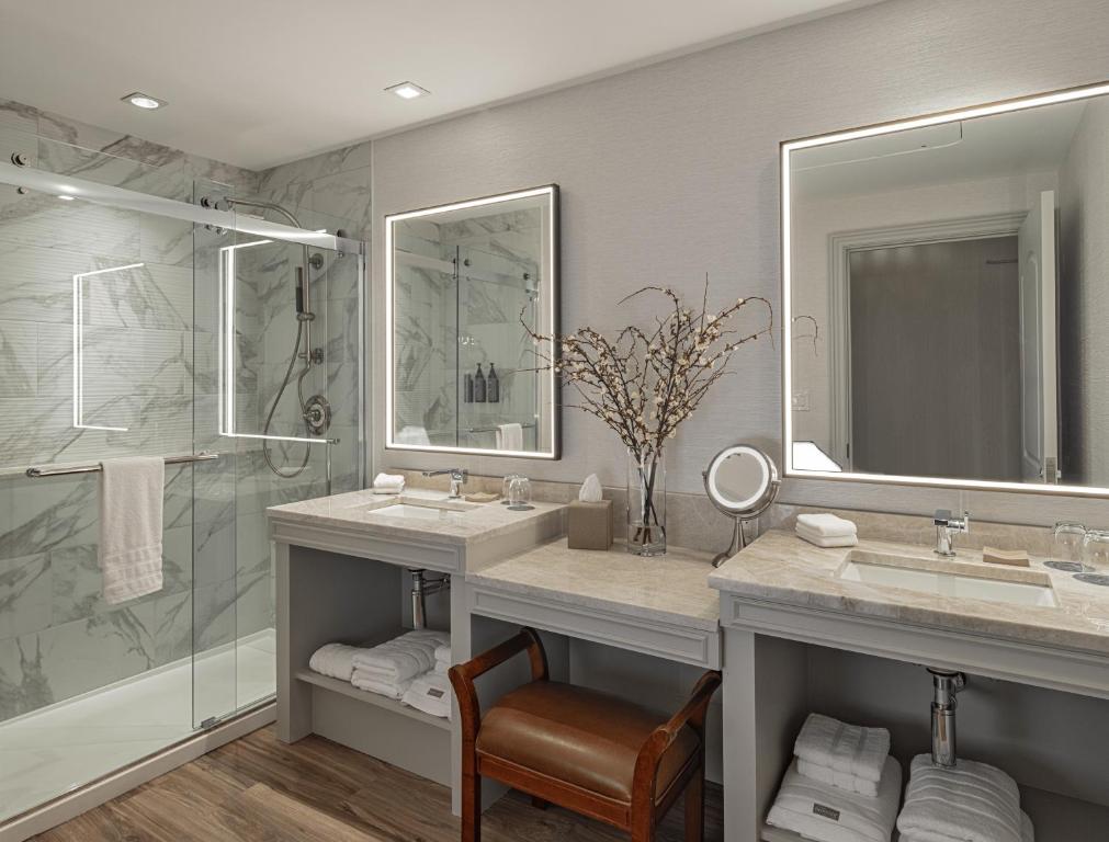 a bathroom with two sinks and a shower at The Westin Houston Downtown in Houston