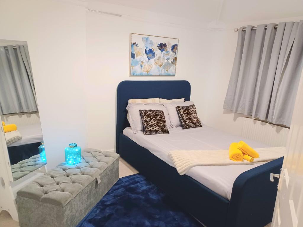 a bedroom with two beds with a blue headboard at Glenmead in Birmingham
