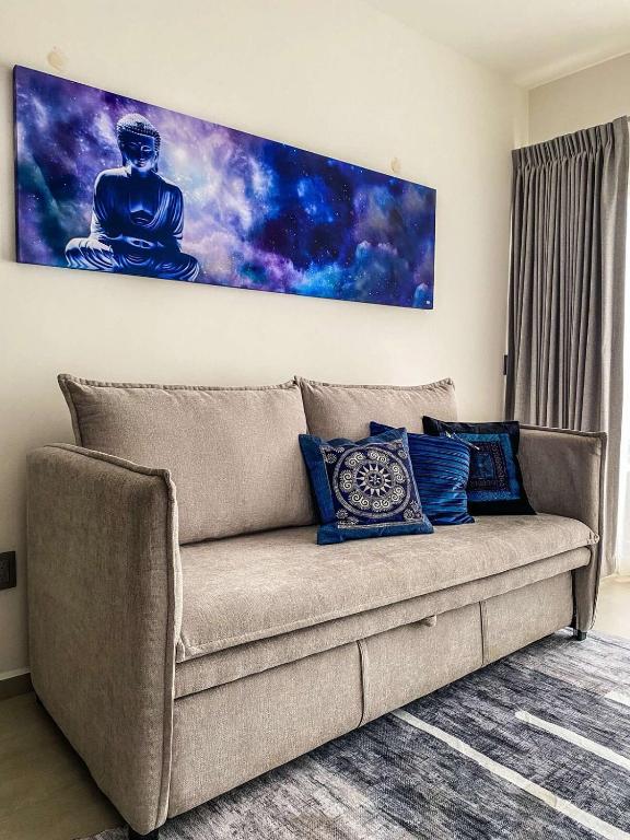 a couch in a living room with a painting on the wall at Beautiful Celeste Condominium in La Paz
