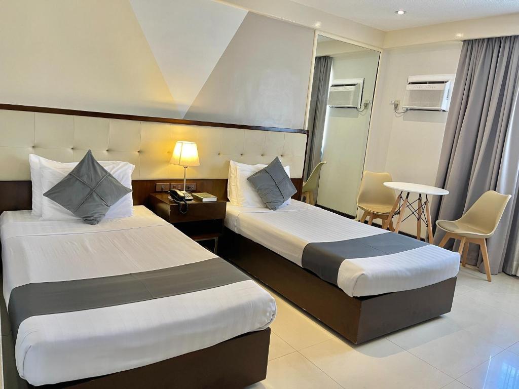 Postel nebo postele na pokoji v ubytování The VIP Hotel