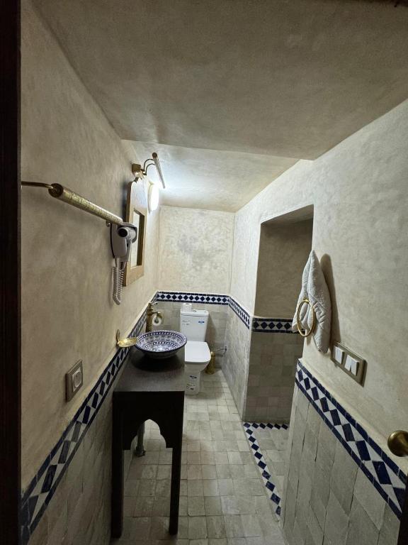 a bathroom with a sink and a toilet at Riad M'Barka in Tangier