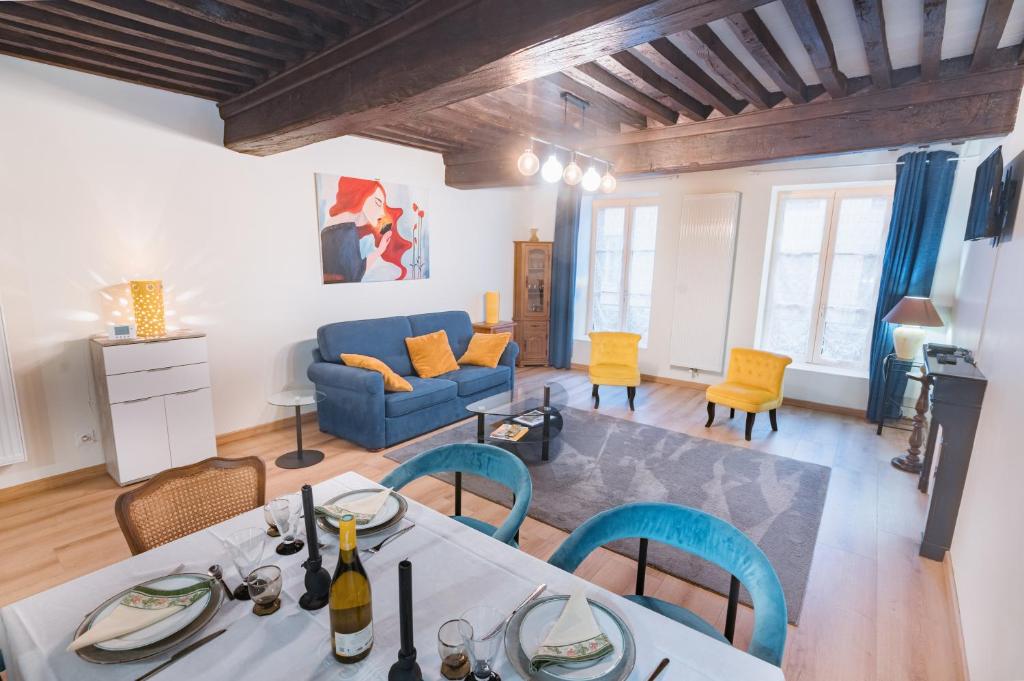 un salon avec une table, des chaises et un canapé dans l'établissement La Traige du Midi, à Tournus