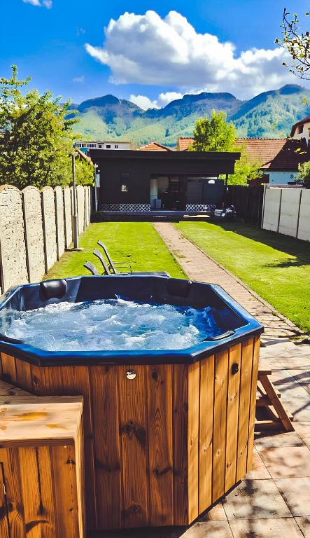 a hot tub in the backyard of a house at Alpine Crown in Zărneşti