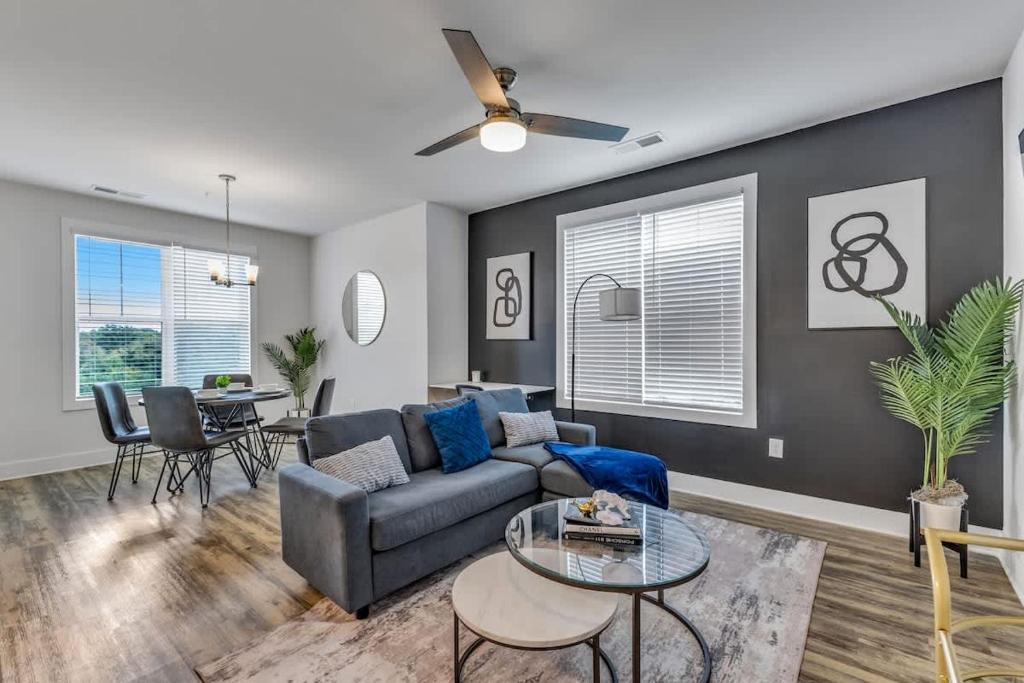 a living room with a couch and a table at Luxurious King 2BR Suite Mins to Downtown Durham! in Durham