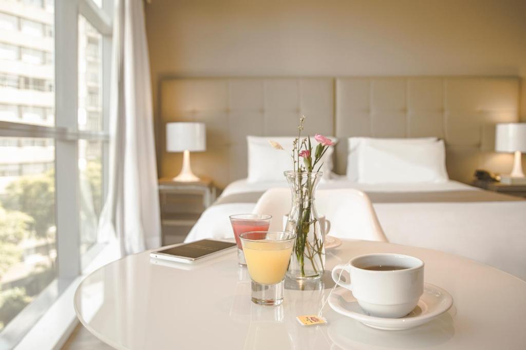Postel nebo postele na pokoji v ubytování Vivaldi Hotel Loft Punta Carretas