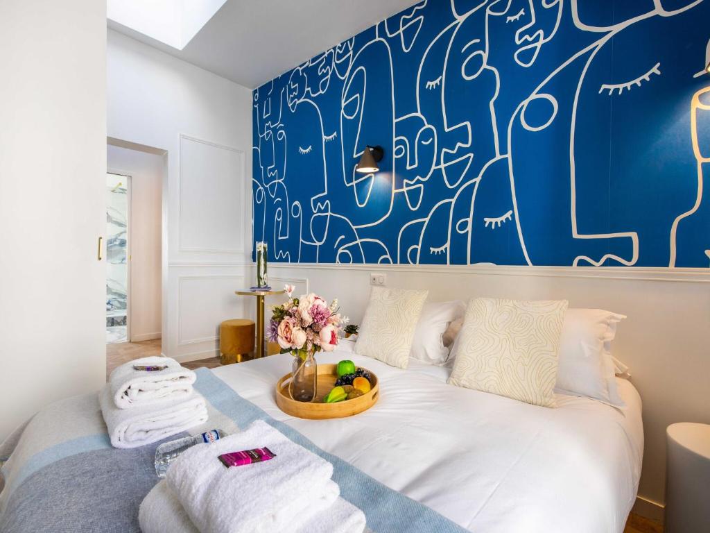 une chambre avec un lit avec un mur bleu dans l'établissement Charming studio - 2P - Pigalle Sacré-C ur, à Paris