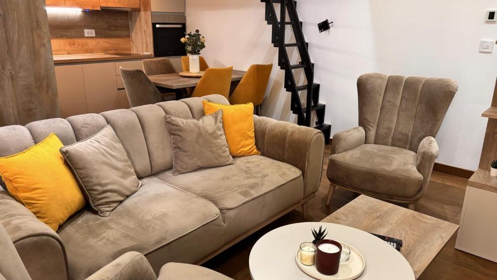a living room with a couch and two chairs at Apartman SN in Zlatibor