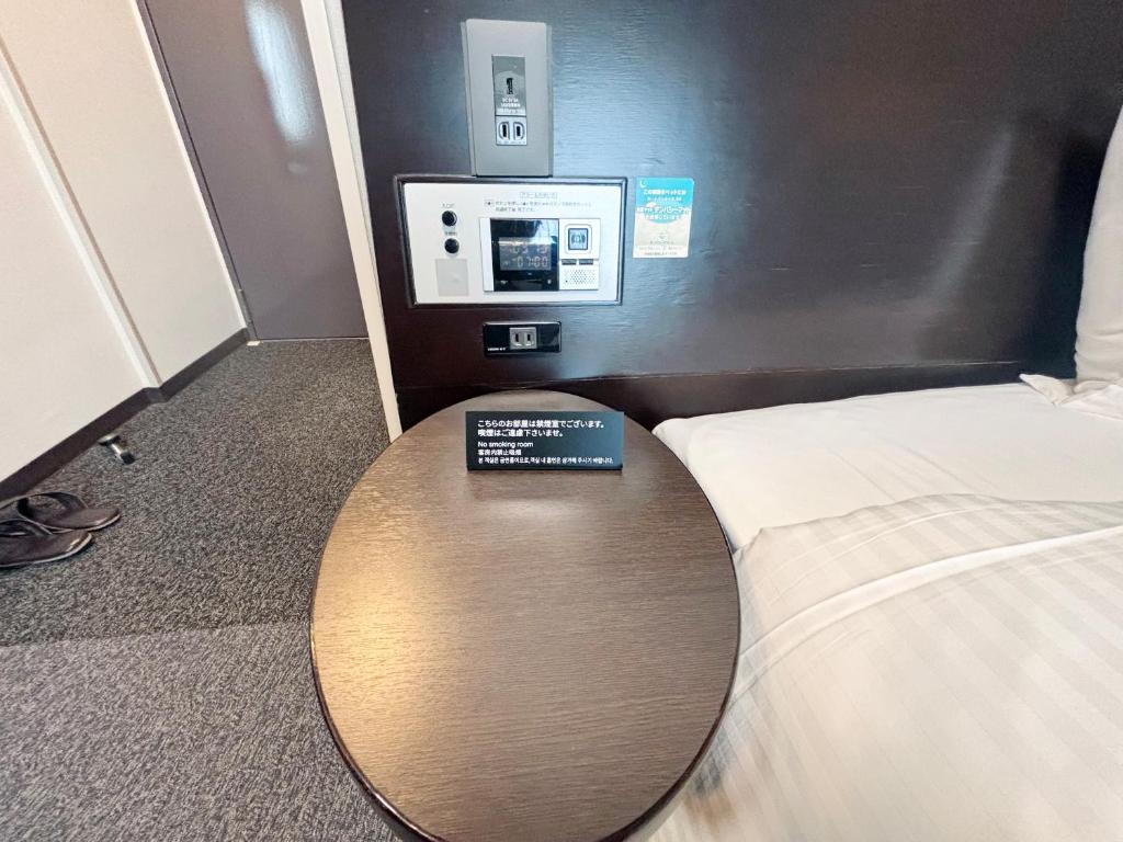Postel nebo postele na pokoji v ubytování Hotel Route-Inn Iyo-Saijo