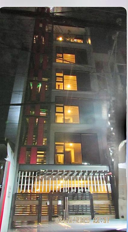 a tall building at night with its lights on at Regner-Quinto Real Estate Services in Cebu City