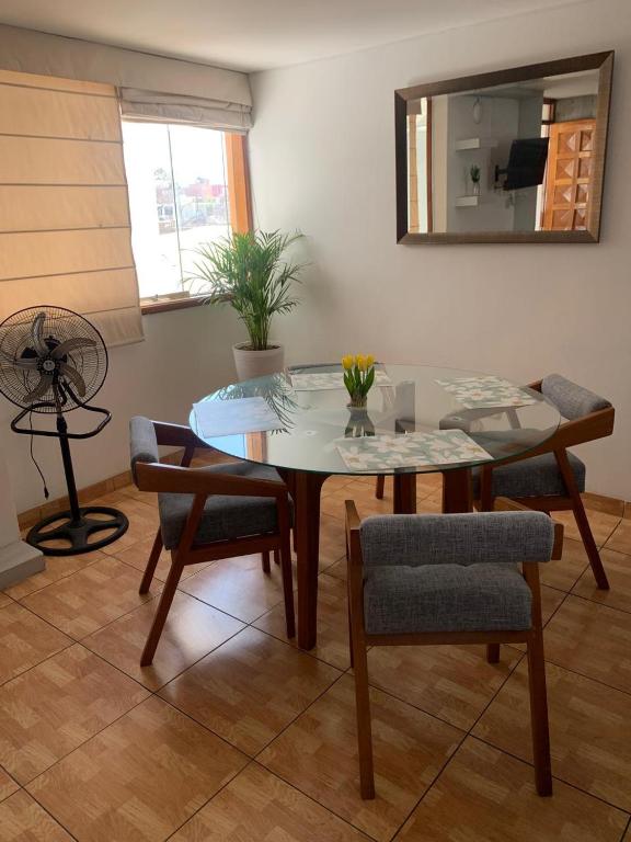 a dining room with a table and chairs and a mirror at Apart Marchelo 2 in San Antonio