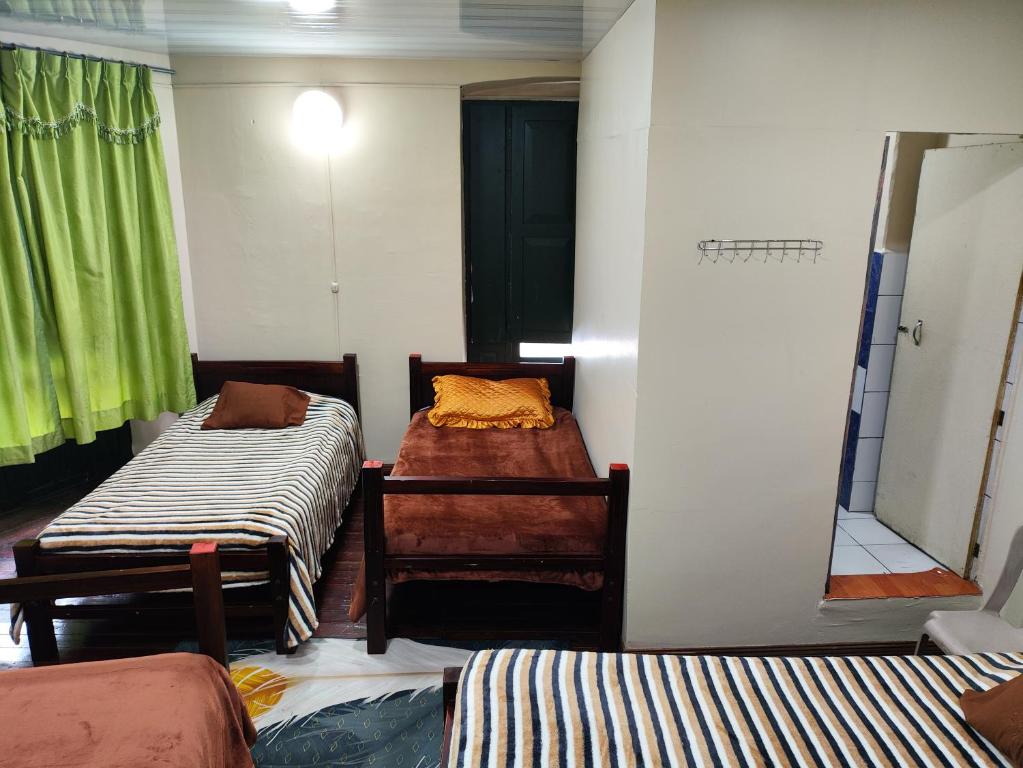 Postel nebo postele na pokoji v ubytování Hostal Latitud Ecuem