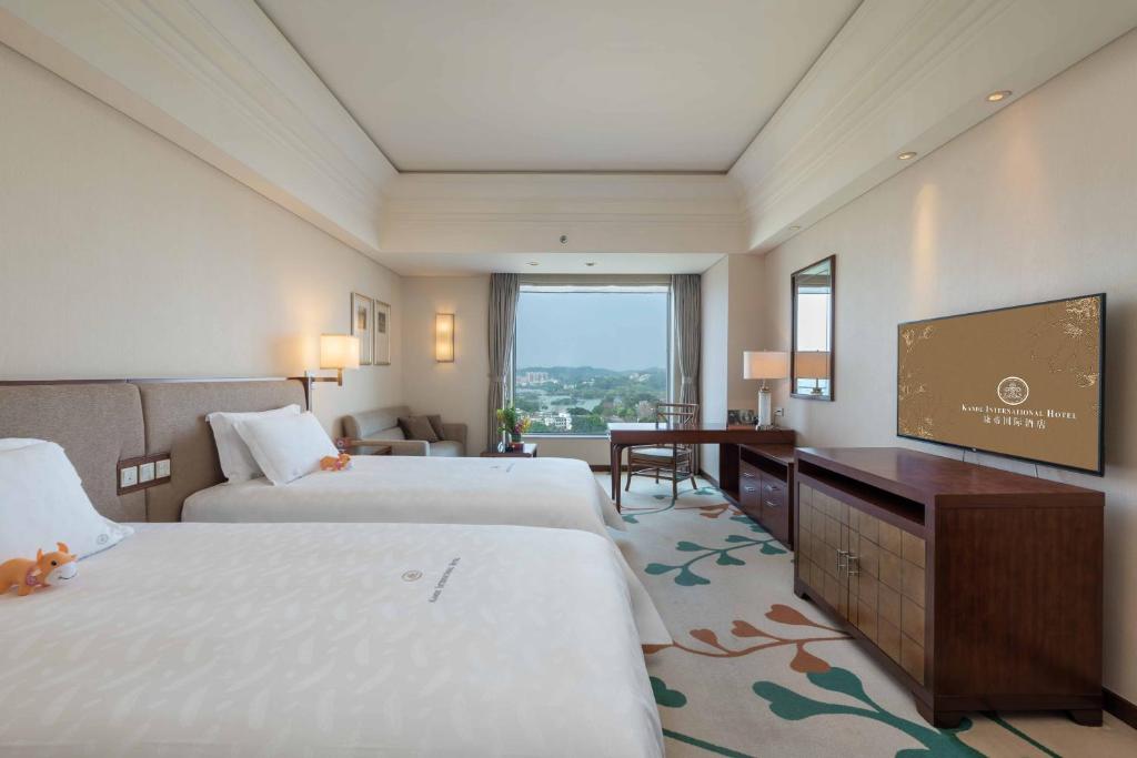 Postel nebo postele na pokoji v ubytování Huizhou Kande International Hotel