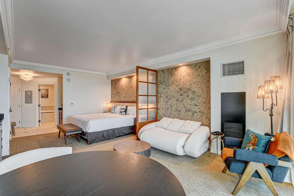 a hotel room with two beds and a table at Amber Crest at The MGM Signature Tower 3 in Las Vegas