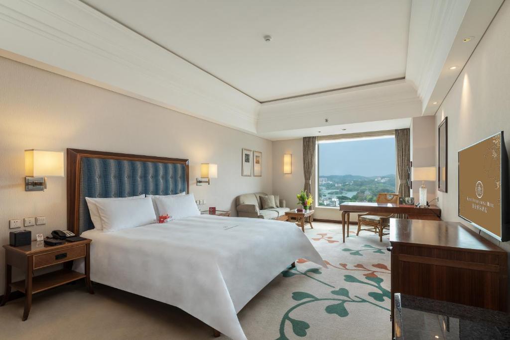 Postel nebo postele na pokoji v ubytování Huizhou Kande International Hotel