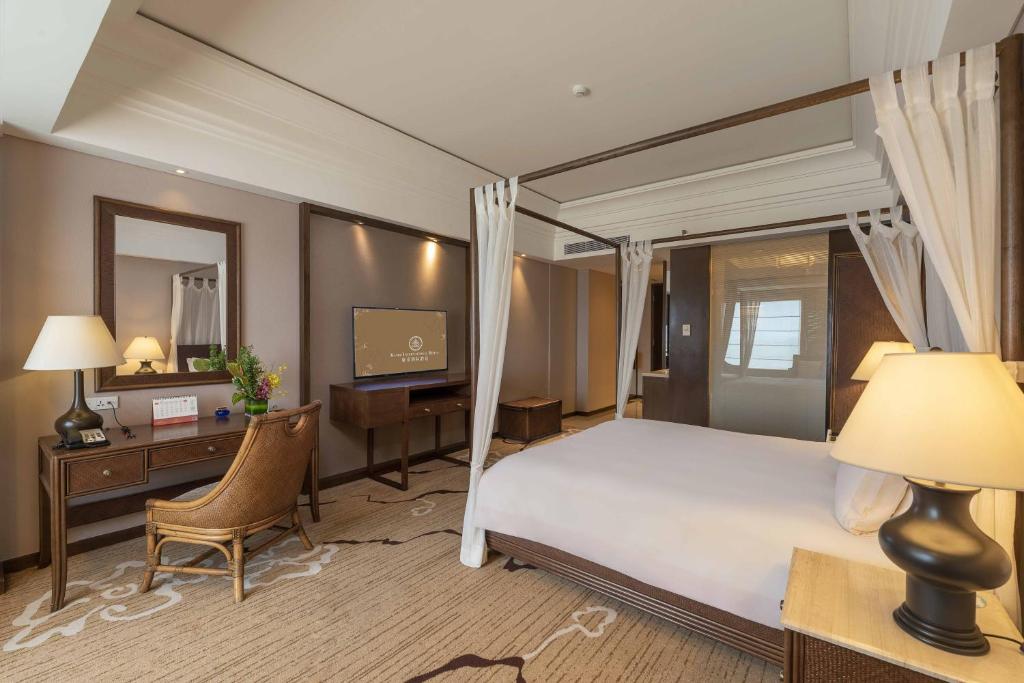 Postel nebo postele na pokoji v ubytování Huizhou Kande International Hotel