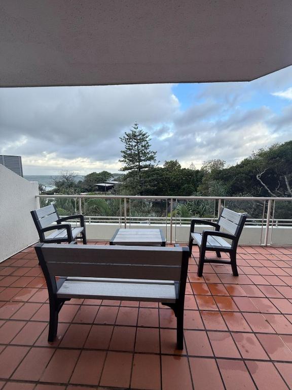 a patio with two chairs and a table on a balcony at Point View at The Sandcastles Resort Mooloolaba in Mooloolaba