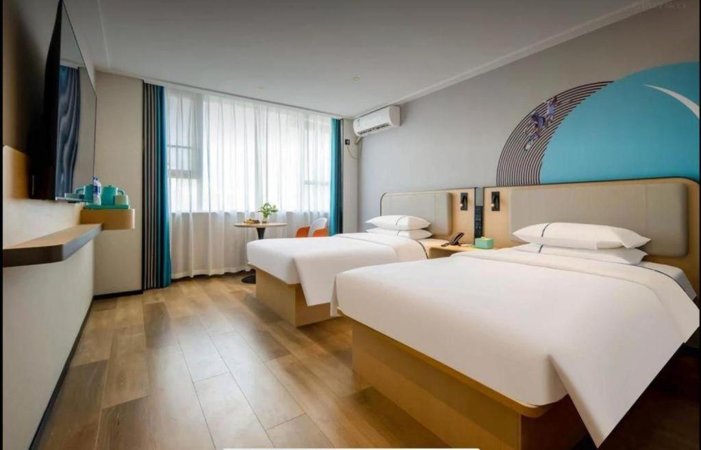 Postel nebo postele na pokoji v ubytování City Comfort Inn Jiangxia Wuchang University of Technology