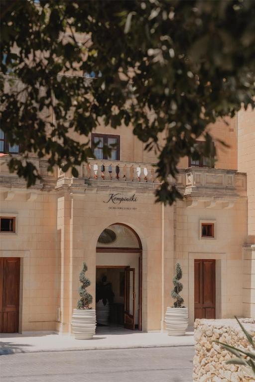 a building with an archway in front of it at Kempinski Hotel San Lawrenz in San Lawrenz
