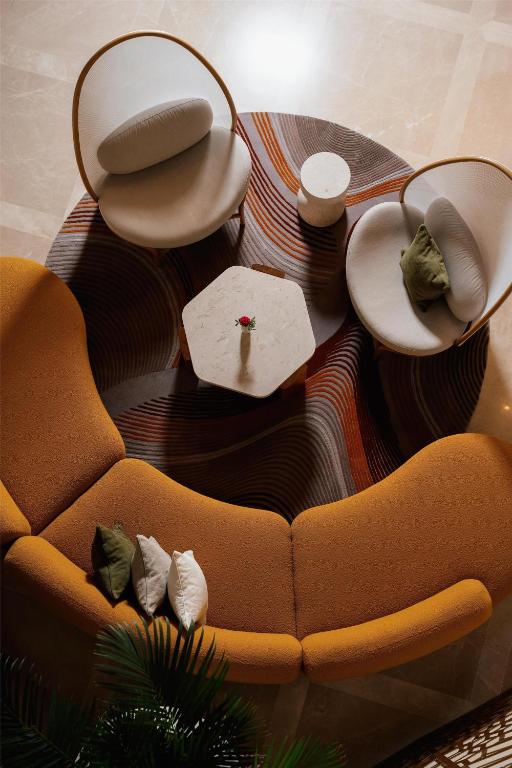 a living room with a couch and a table at Kempinski Hotel San Lawrenz in San Lawrenz