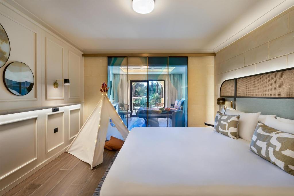 a bedroom with a large bed in a room at Kempinski Hotel San Lawrenz in San Lawrenz