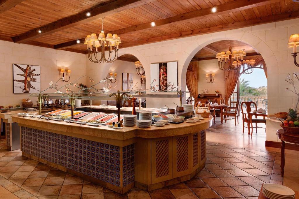 a kitchen with an island in the middle of a room at Kempinski Hotel San Lawrenz in San Lawrenz