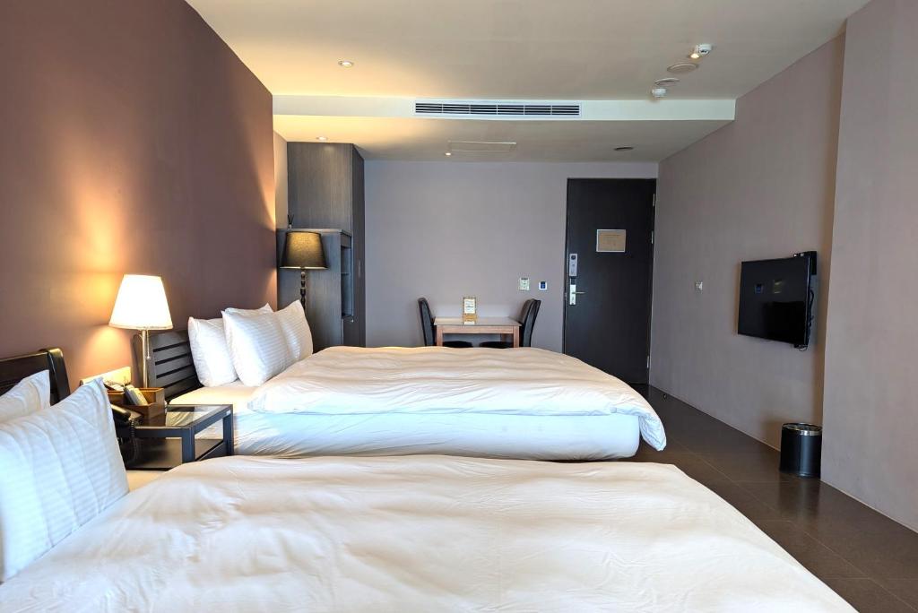 Postelja oz. postelje v sobi nastanitve Jing Guan Hotel