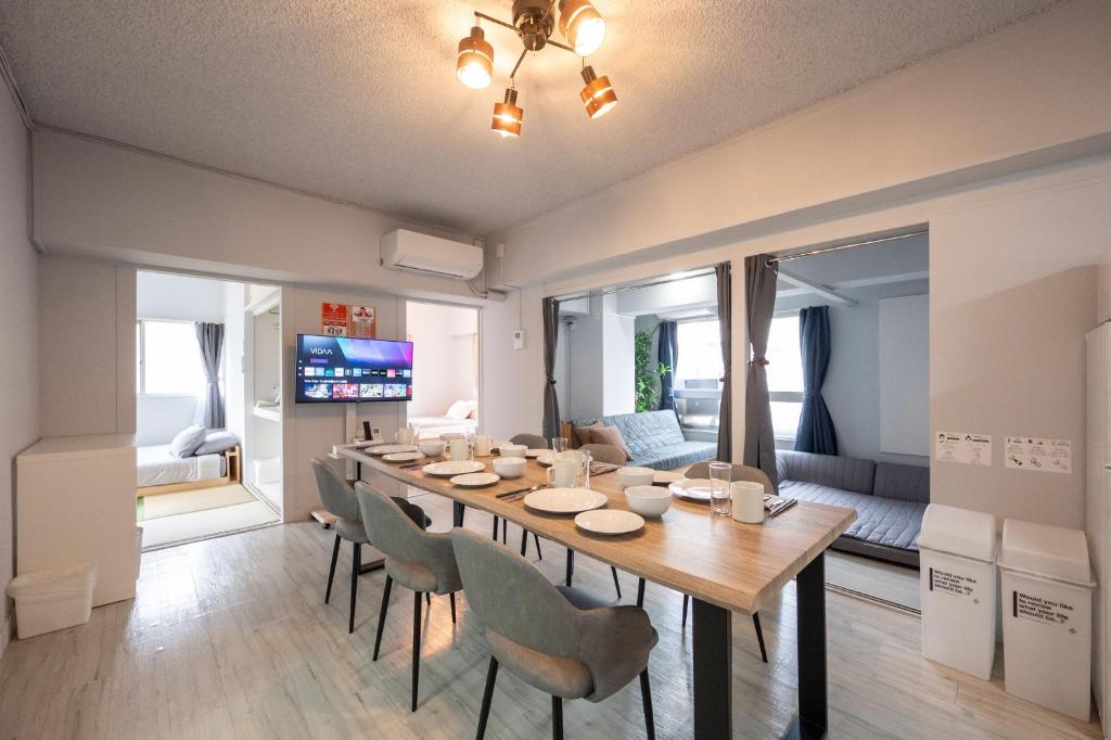 a dining room with a long table and chairs at GoodStay301 in Kurume
