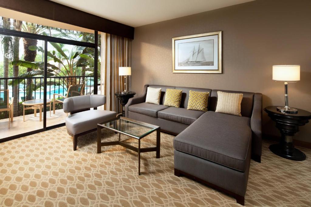 a living room with a couch and a table at Sheraton Park Hotel at the Anaheim Resort in Anaheim