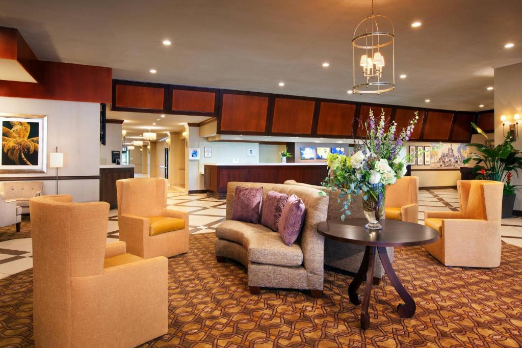 a lobby with couches and a table with flowers on it at Sheraton Park Hotel at the Anaheim Resort in Anaheim
