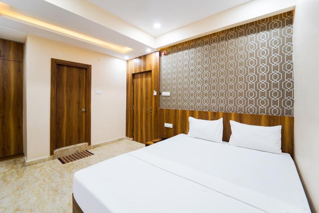 Postel nebo postele na pokoji v ubytování Hotel O GM