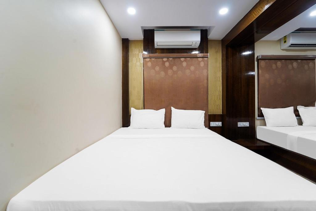Postel nebo postele na pokoji v ubytování Hotel O GM