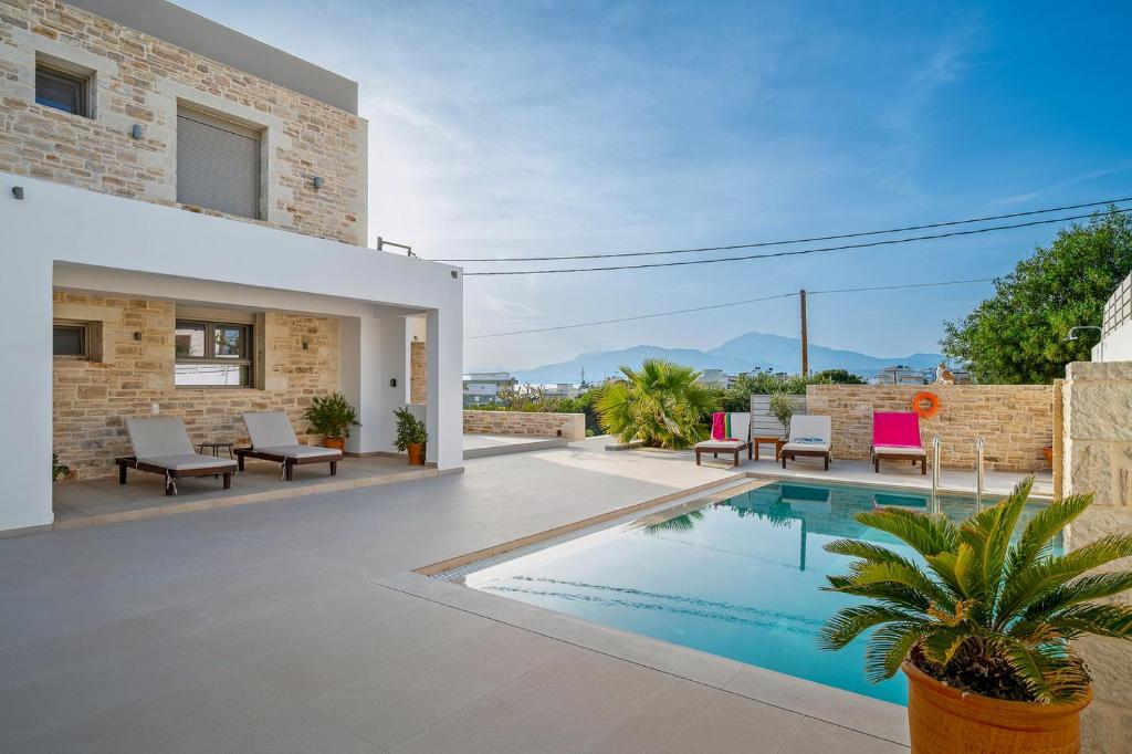 The swimming pool at or close to Ammokrinos Luxury Homes, 150m From Sea