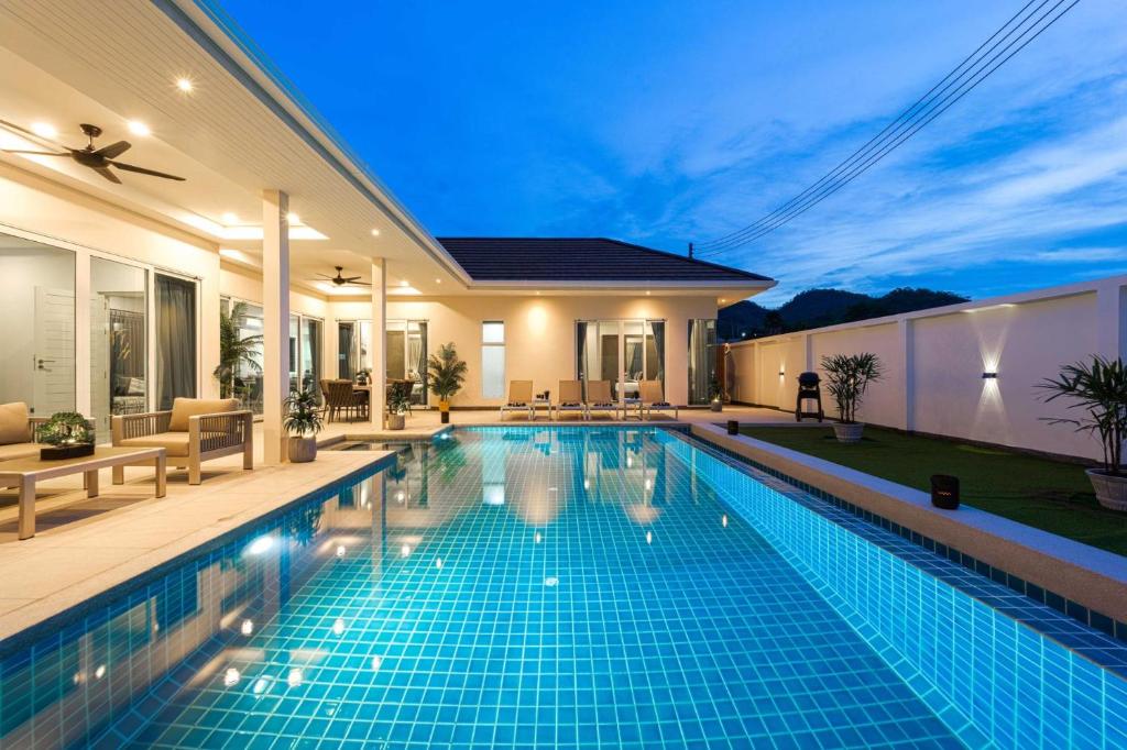a swimming pool in a villa at night at Modern Villa 3BR - Great Location - KL3 in Hua Hin