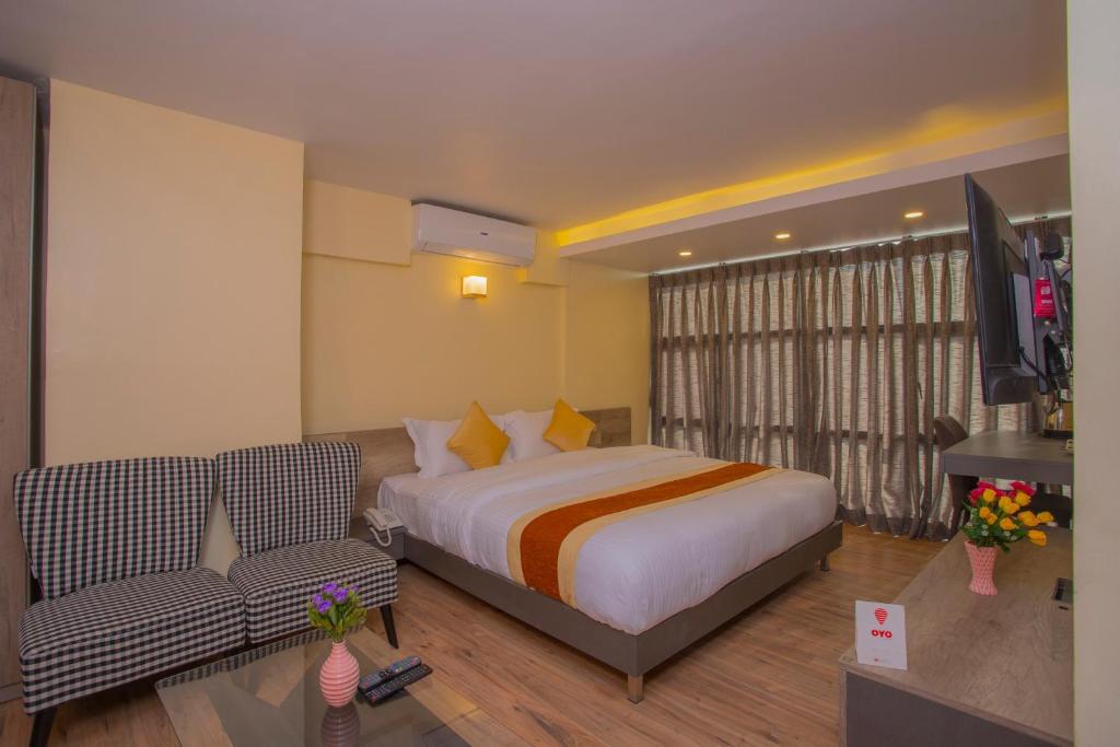 Postel nebo postele na pokoji v ubytování OYO 262 Hotel Kumari