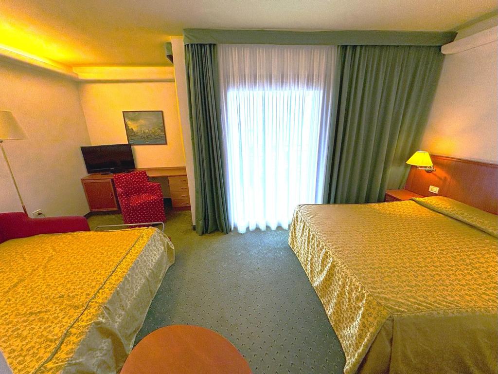 Postel nebo postele na pokoji v ubytování Hotel Rialto